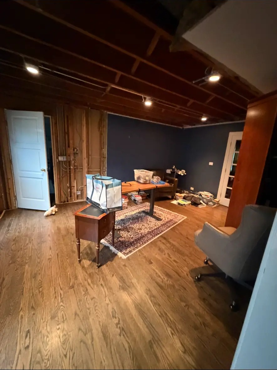 Basement office with exposed framing before finishing work