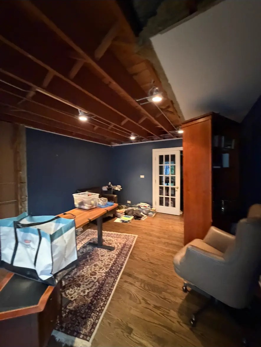 Basement office after painting and trim with a deep blue accent wall